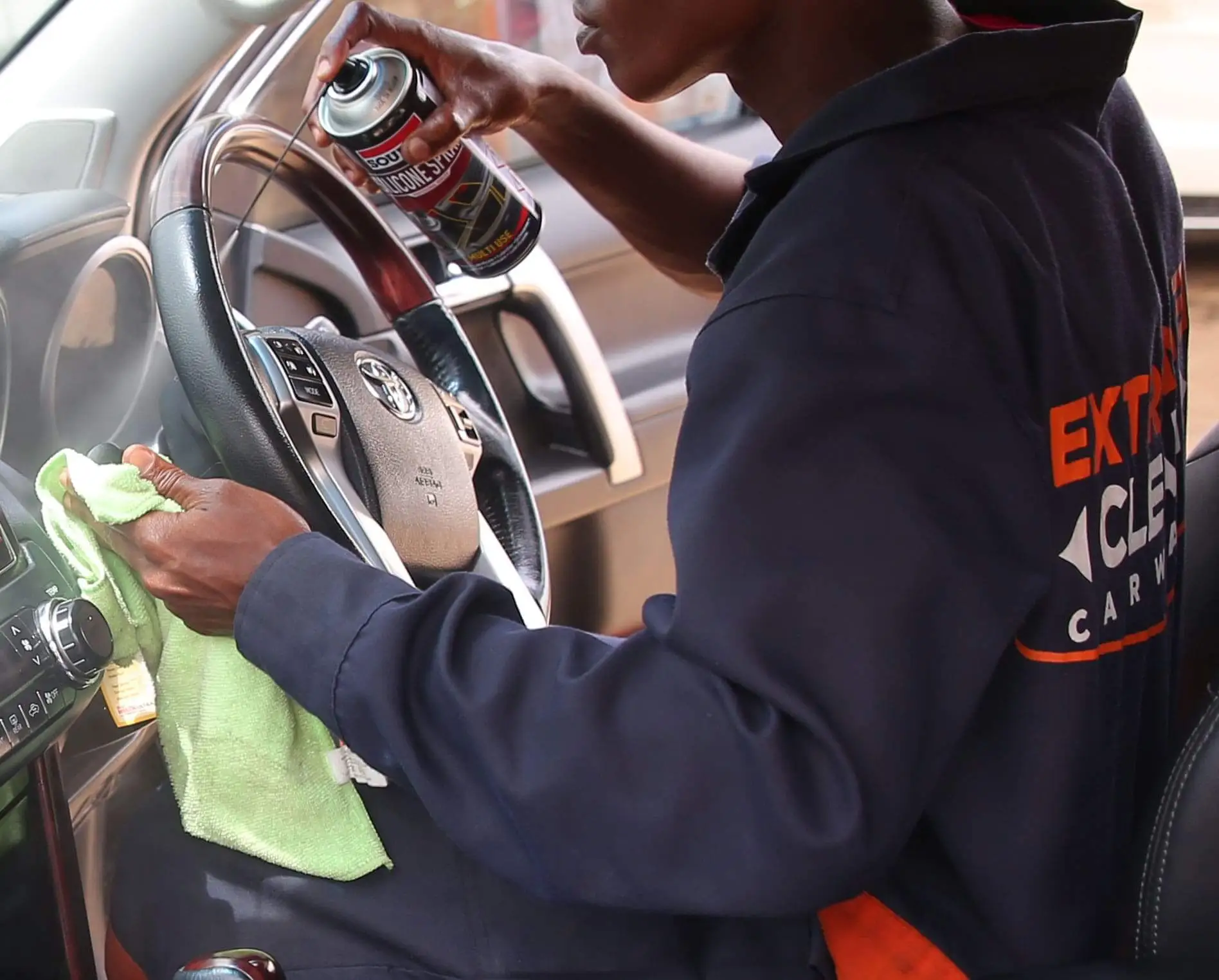 Professional vehicle interior cleaning team at work